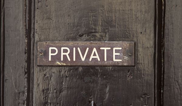 a close up of a street sign on top of a wooden door